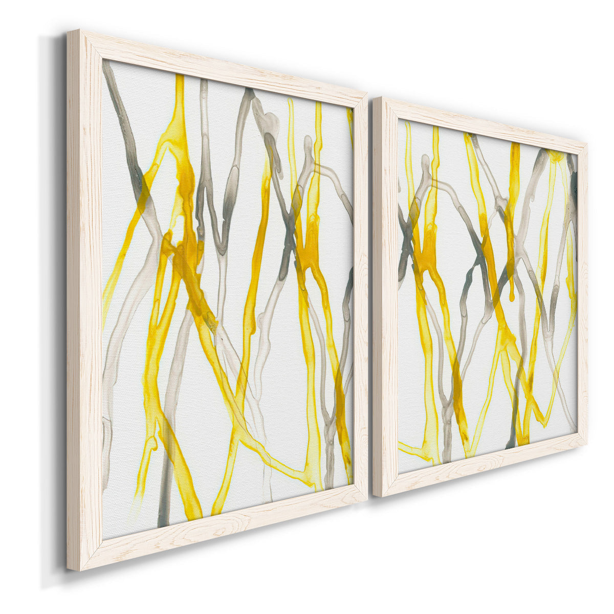 Angled view of a set of two white barnwood framed canvas prints featuring two fluid organic abstracts featuring branching watercolor lines drifting across white.