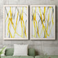 Set of two white barnwood framed canvas prints depicting a coordinated art pair of branching watercolor lines drifting across white rendered as fluid organic abstracts above a sofa in a modern living room.