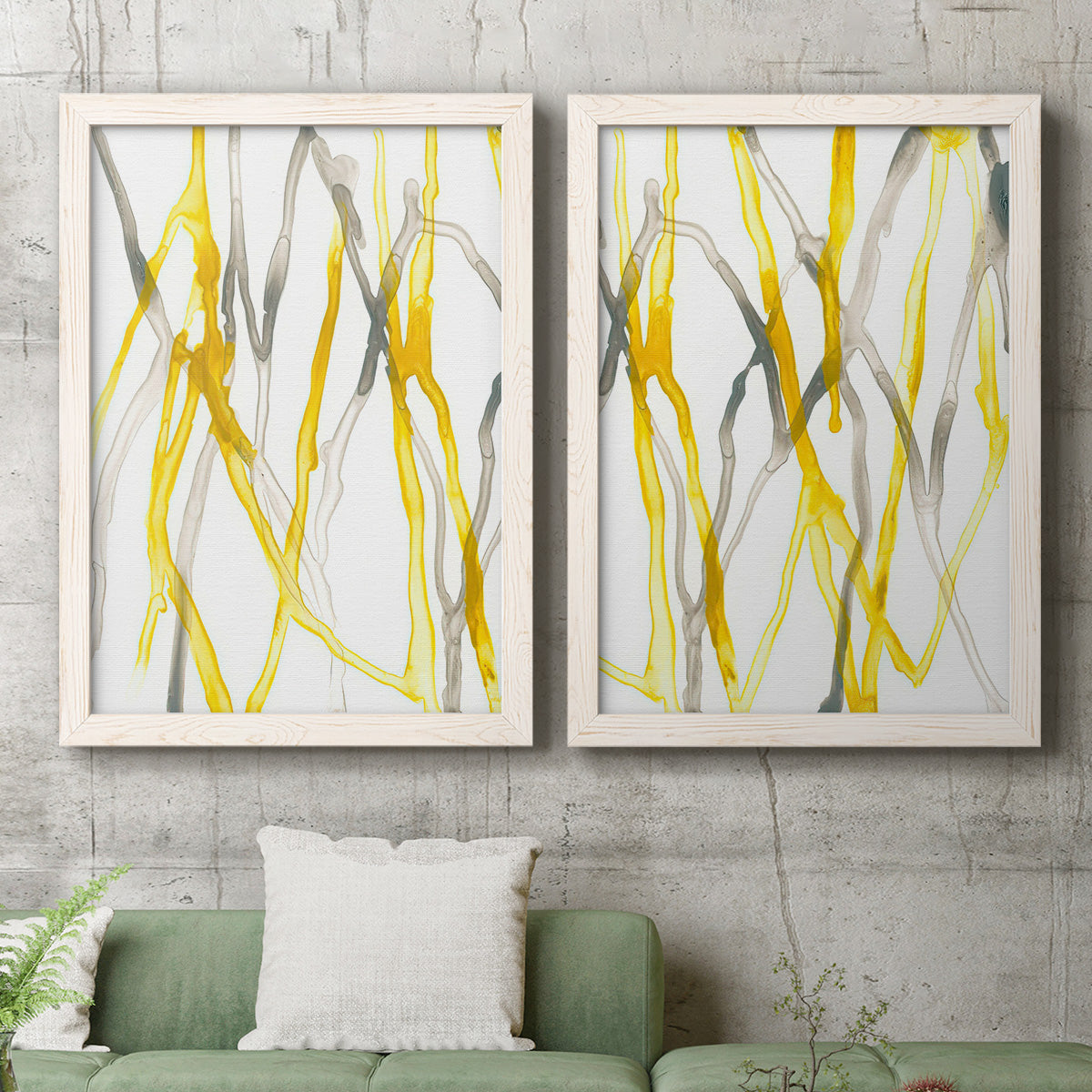Set of two white barnwood framed canvas prints depicting a coordinated art pair of branching watercolor lines drifting across white rendered as fluid organic abstracts above a sofa in a modern living room.