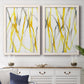 Set of two white barnwood framed canvas prints depicting a coordinated art pair of branching watercolor lines drifting across white rendered as fluid organic abstracts above a dining room sideboard.