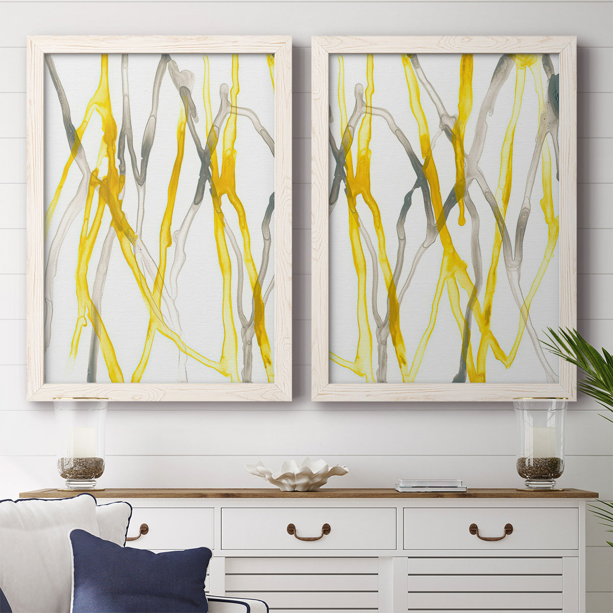 Set of two white barnwood framed canvas prints depicting a coordinated art pair of branching watercolor lines drifting across white rendered as fluid organic abstracts above a dining room sideboard.