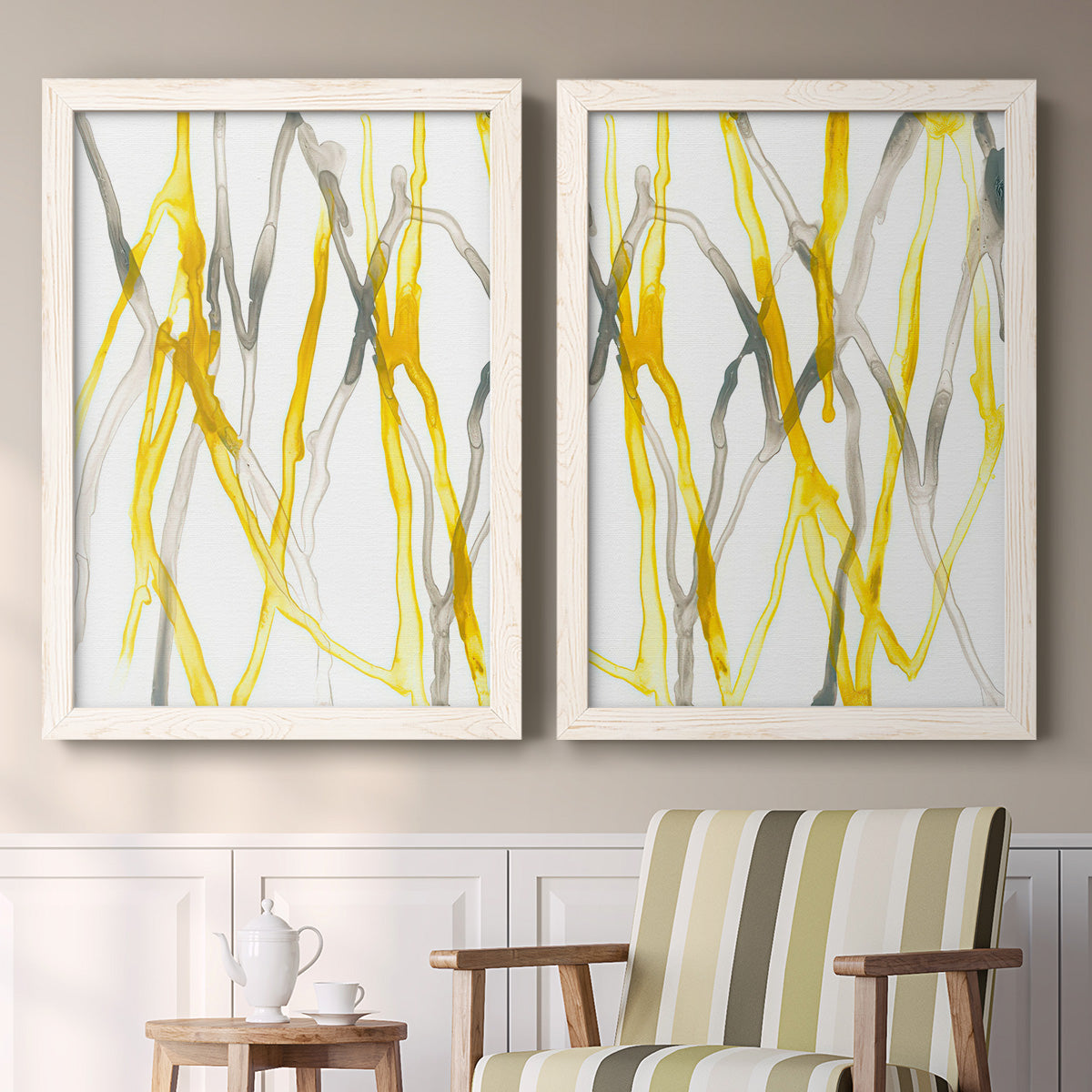 Set of two white barnwood framed canvas prints depicting two fluid organic abstracts featuring branching watercolor lines drifting across white above a sideboard in a cozy sitting room.