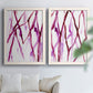 Set of two white barnwood framed canvas prints depicting slender vein-like strokes, transparent overlaps, and open negative space arranged across two complementary compositions above a sofa in a bright living space.