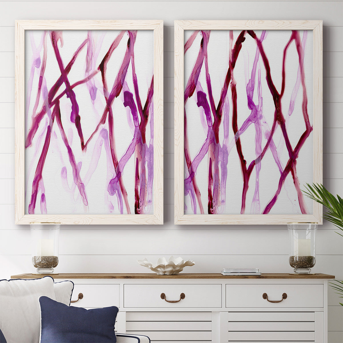 Set of two white barnwood framed canvas prints depicting a coordinated art pair of branching watercolor lines drifting across white rendered as fluid organic abstracts above a dining room sideboard.
