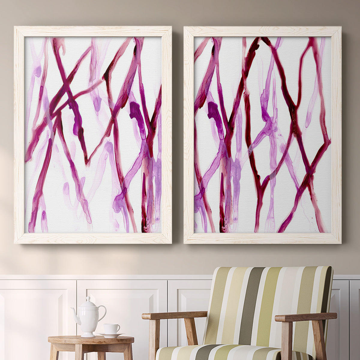 Set of two white barnwood framed canvas prints depicting two fluid organic abstracts featuring branching watercolor lines drifting across white above a sideboard in a cozy sitting room.