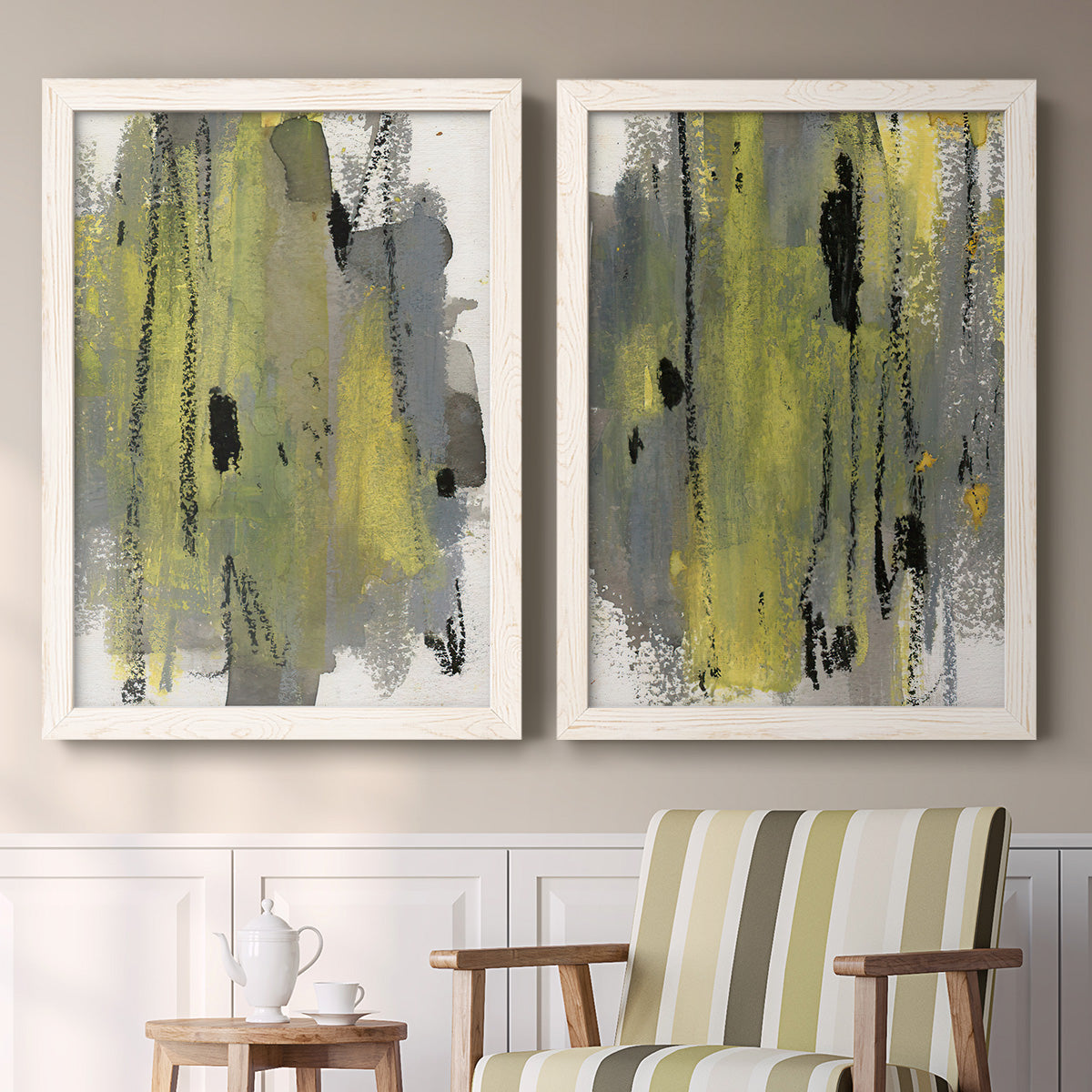 Set of two white barnwood framed canvas prints depicting two urban mixed-media abstracts featuring vertical abstract brush bands in changing muted palettes above a sideboard in a cozy sitting room.