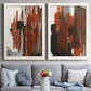 Set of two white barnwood framed canvas prints depicting paired urban mixed-media abstracts with scraped paint, black accents, and layered gray green rust or yellow fields above a sofa in a contemporary living room.