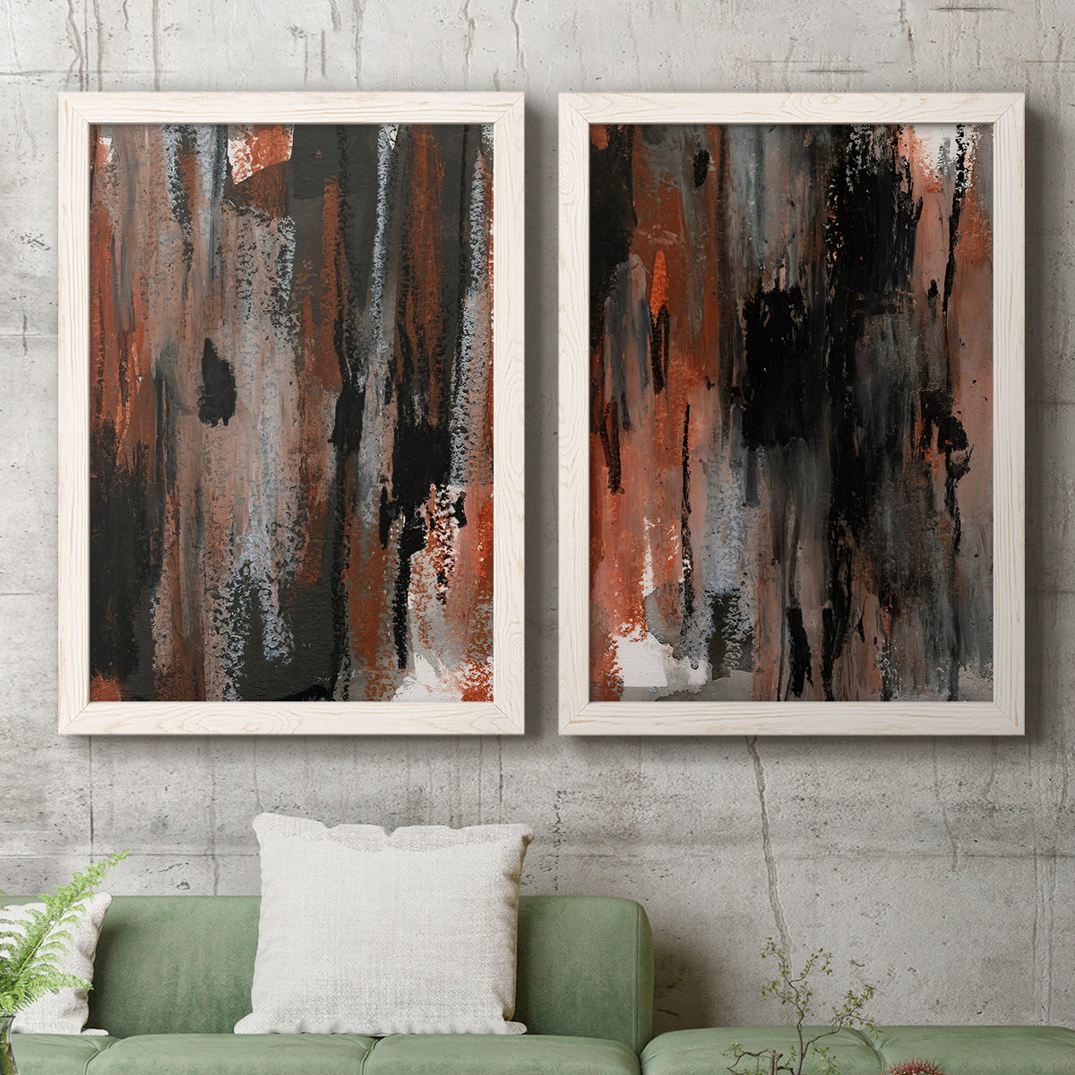 Set of two white barnwood framed canvas prints depicting a coordinated art pair of vertical abstract brush bands in changing muted palettes rendered as urban mixed-media abstracts above a sofa in a modern living room.