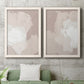 Set of two white barnwood framed canvas prints depicting a coordinated art pair of soft taupe blush and white paint blocks rendered as neutral minimalist abstracts above a sofa in a modern living room.