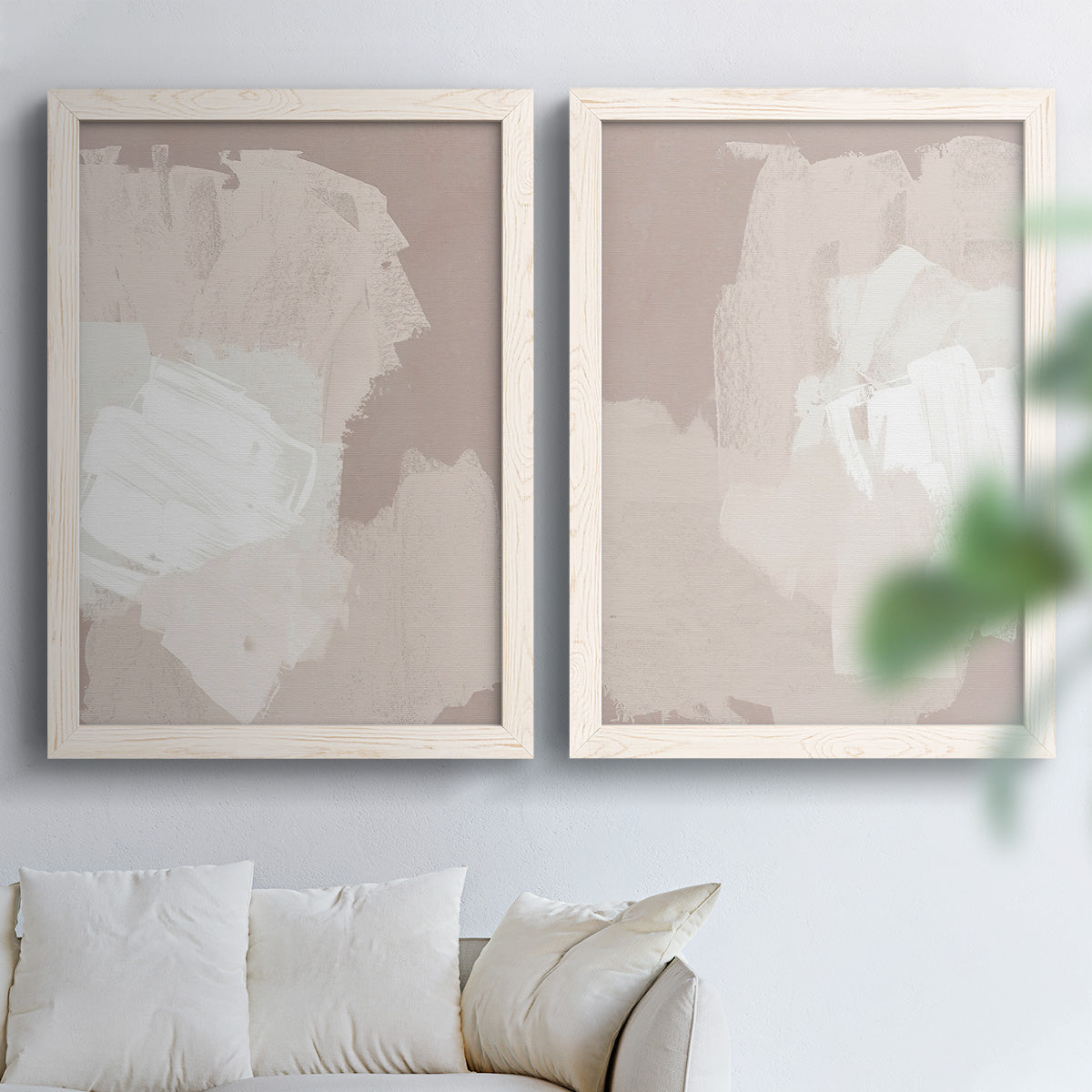 Set of two white barnwood framed canvas prints depicting broad rectangular strokes, cloudy overlaps, and subtle texture arranged across two complementary compositions above a sofa in a bright living space.