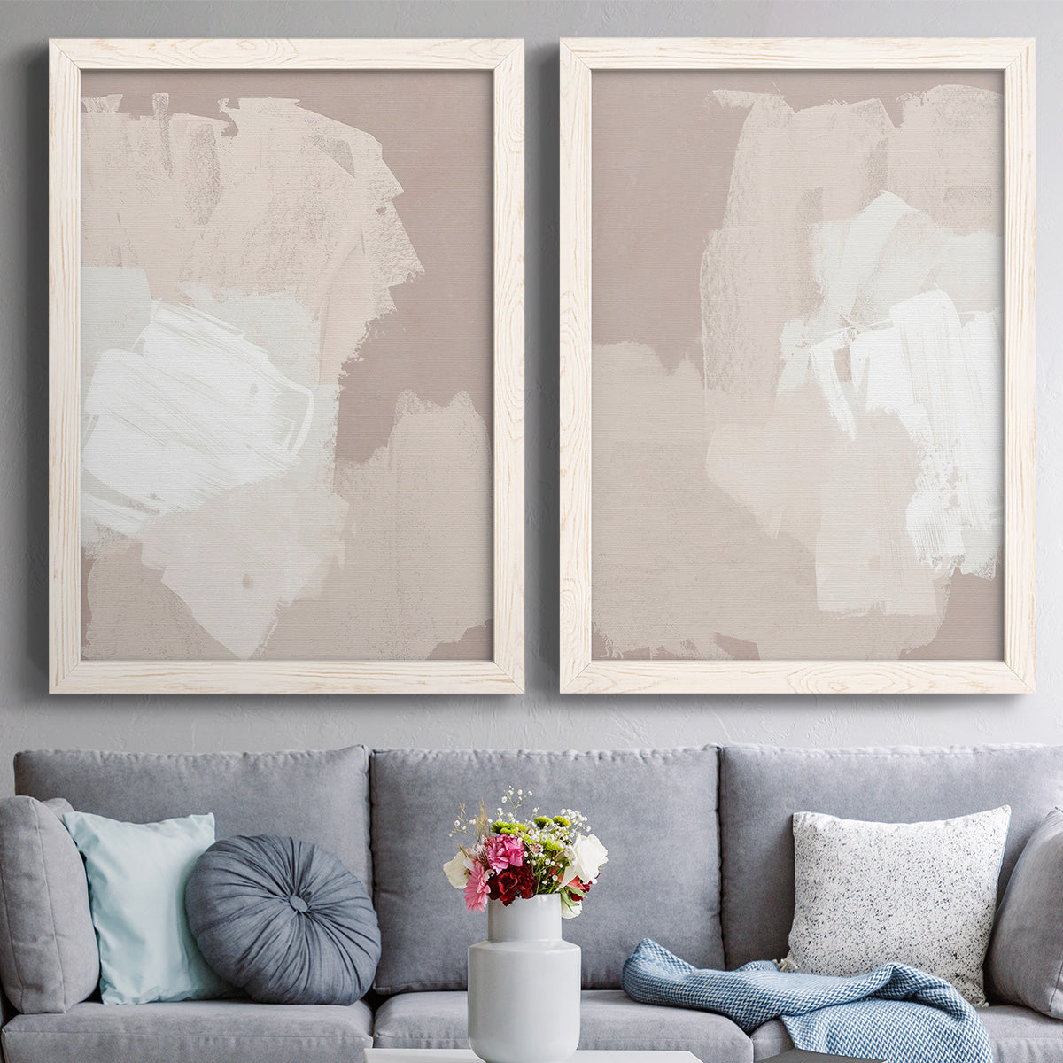 Set of two white barnwood framed canvas prints depicting paired neutral minimalist abstracts with broad rectangular strokes, cloudy overlaps, and subtle texture above a sofa in a contemporary living room.