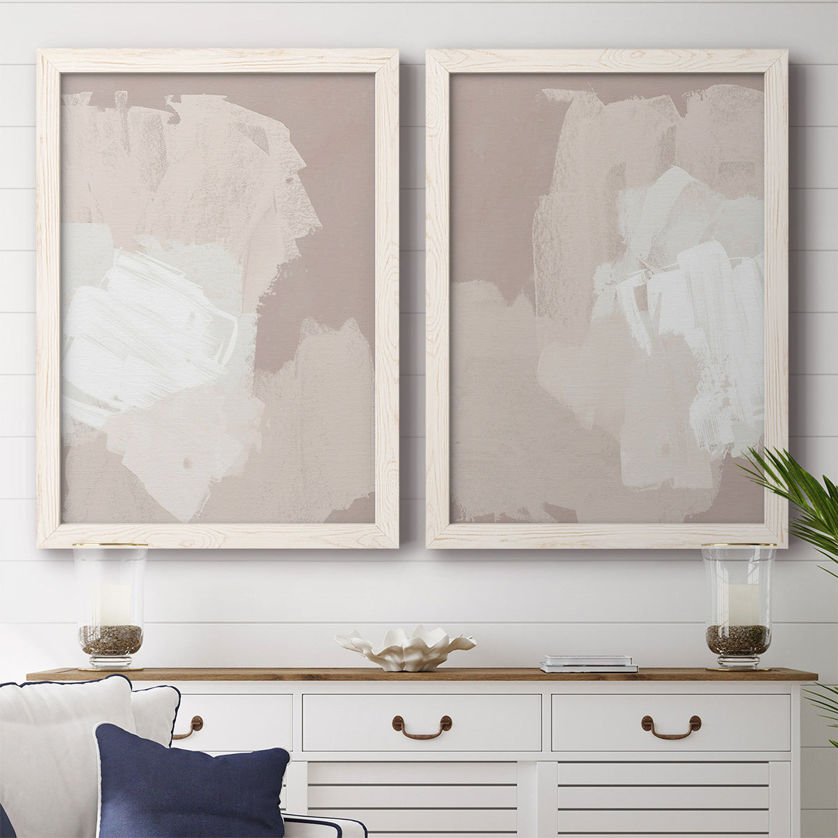 Set of two white barnwood framed canvas prints depicting a coordinated art pair of soft taupe blush and white paint blocks rendered as neutral minimalist abstracts above a dining room sideboard.