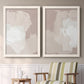 Set of two white barnwood framed canvas prints depicting two neutral minimalist abstracts featuring soft taupe blush and white paint blocks above a sideboard in a cozy sitting room.