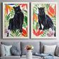 Set of two white barnwood framed canvas prints depicting paired vibrant watercolor wildlife illustrations with dark feline figures, broad green leaves, and bright red and orange flowers above a sofa in a contemporary living room.