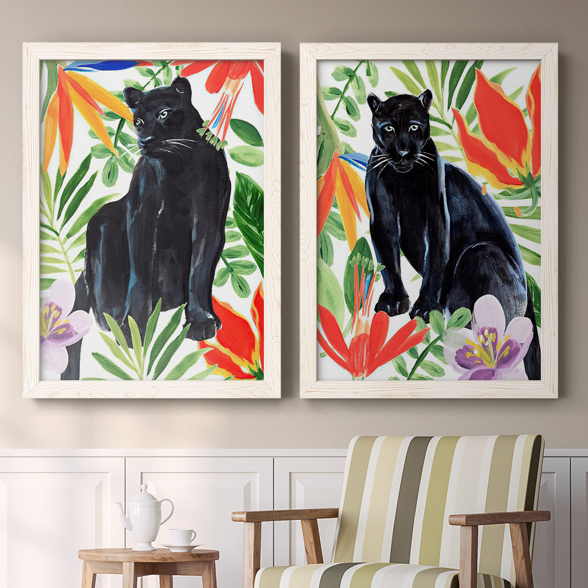 Set of two white barnwood framed canvas prints depicting two vibrant watercolor wildlife illustrations featuring black panthers surrounded by colorful tropical foliage above a sideboard in a cozy sitting room.