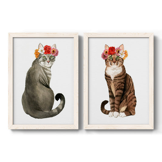 Set of two white barnwood framed canvas prints featuring two whimsical animal portraits featuring seated cats wearing colorful flower crowns.