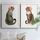 Set of two white barnwood framed canvas prints depicting tabby fur, pink orange and yellow blossoms, and clean white grounds arranged across two complementary compositions above a sofa in a bright living space.