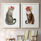 Set of two white barnwood framed canvas prints depicting two whimsical animal portraits featuring seated cats wearing colorful flower crowns above a sideboard in a cozy sitting room.