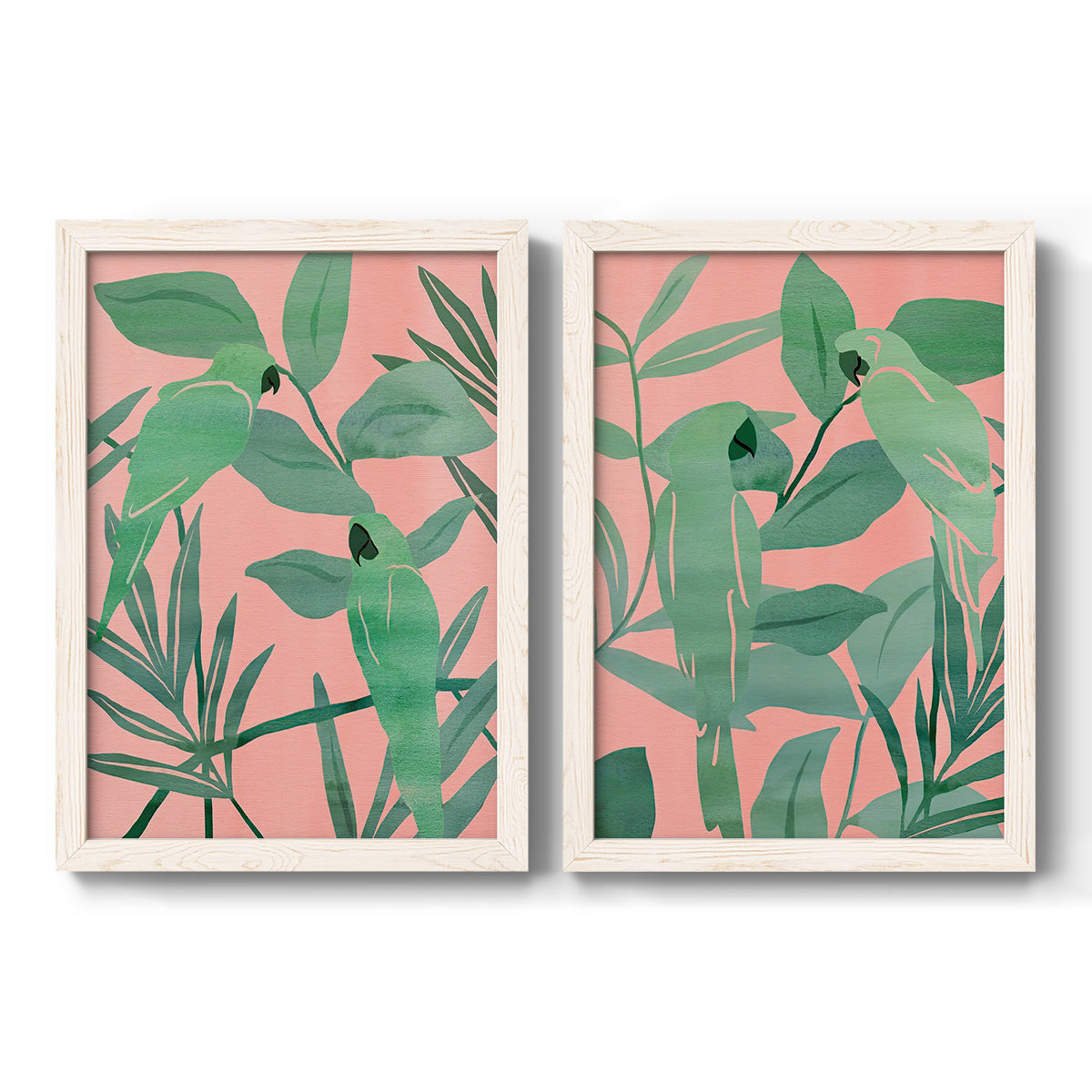 Set of two white barnwood framed canvas prints featuring two bold tropical botanical prints featuring large green tropical leaves on coral-pink grounds.