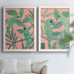 Set of two white barnwood framed canvas prints depicting overlapping foliage, flat graphic shapes, and high-contrast color arranged across two complementary compositions above a sofa in a bright living space.