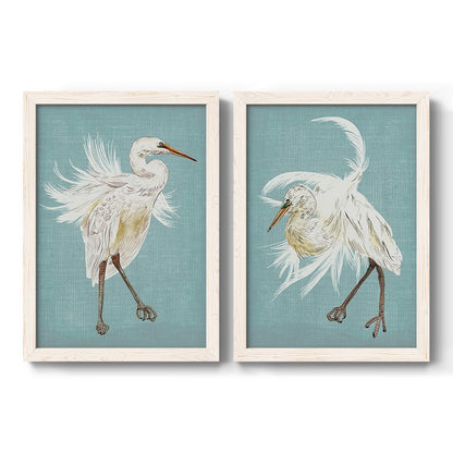 Set of two white barnwood framed canvas prints featuring two decorative bird illustrations featuring white herons displaying long windswept feathers.