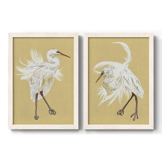 Set of two white barnwood framed canvas prints featuring two decorative bird illustrations featuring white herons displaying long windswept feathers.
