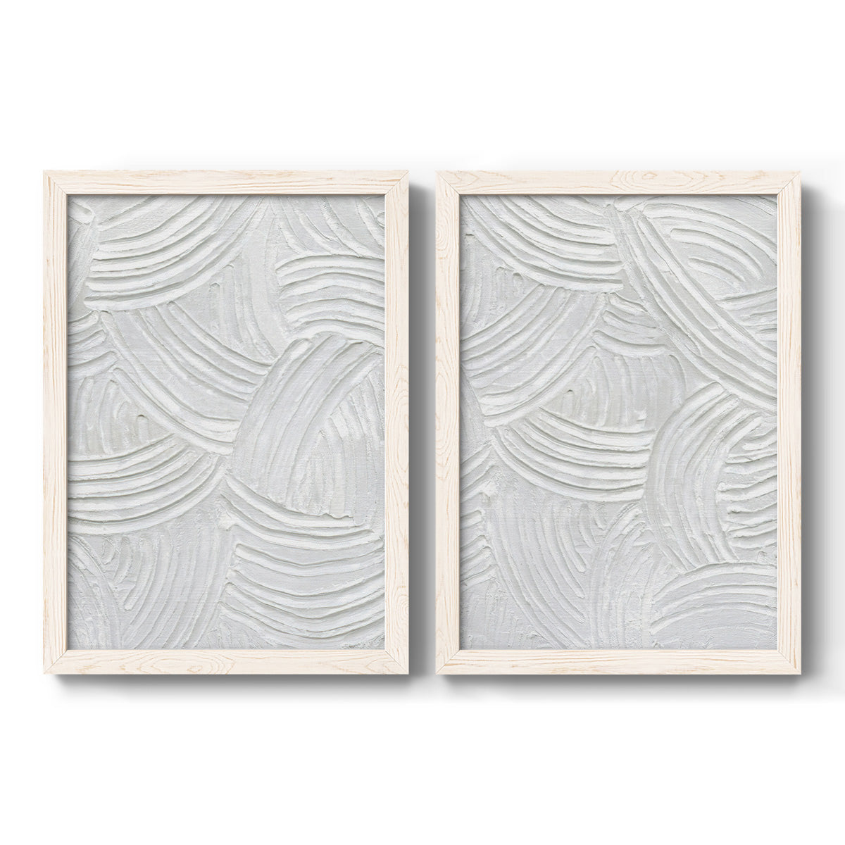 Set of two white barnwood framed canvas prints featuring two textural monochrome abstracts featuring overlapping white carved arcs and ridges.