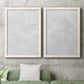Set of two white barnwood framed canvas prints depicting a coordinated art pair of overlapping white carved arcs and ridges rendered as textural monochrome abstracts above a sofa in a modern living room.
