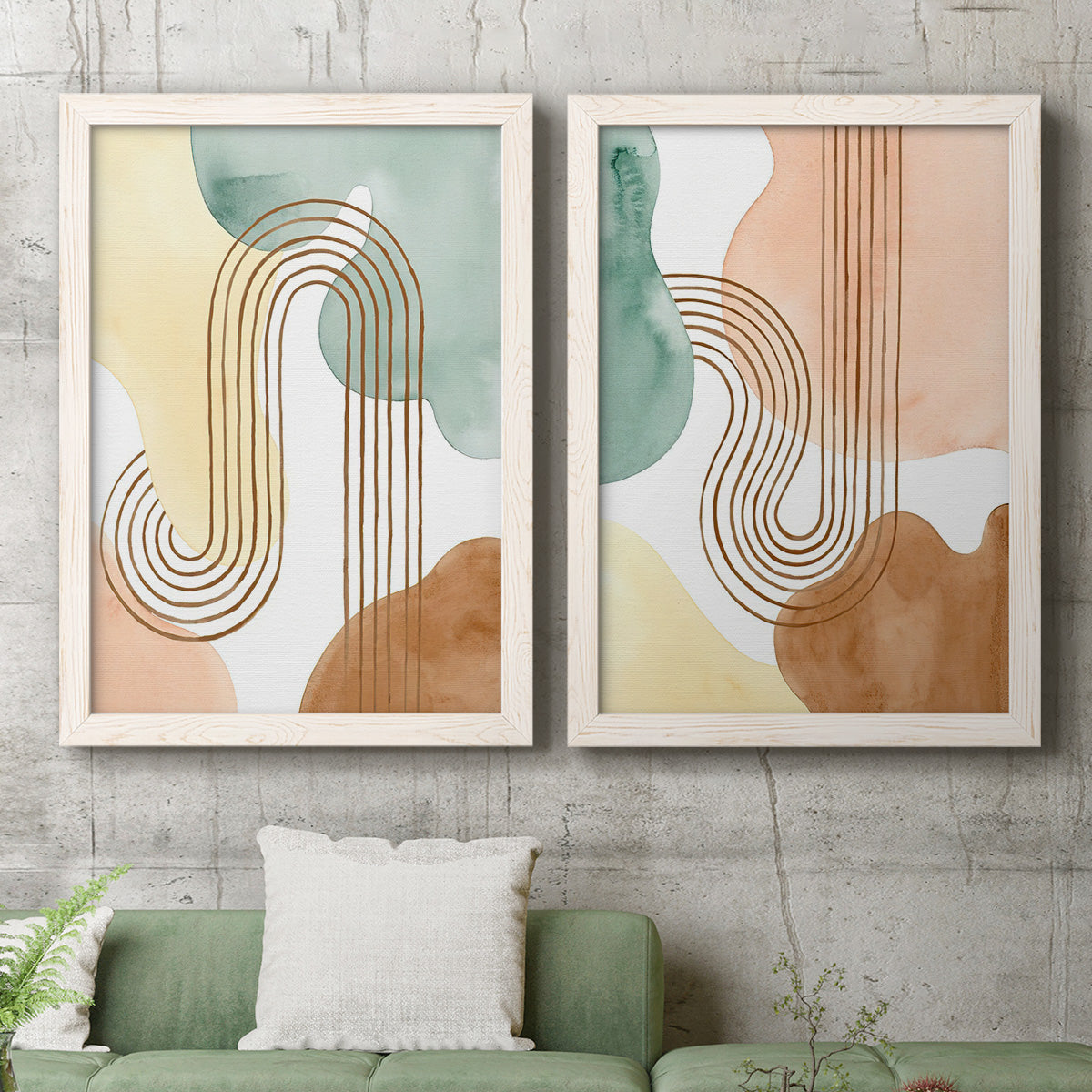 Set of two white barnwood framed canvas prints depicting a coordinated art pair of repeating indigo floral and leaf motifs rendered as folk-inspired botanical patterns above a sofa in a modern living room.