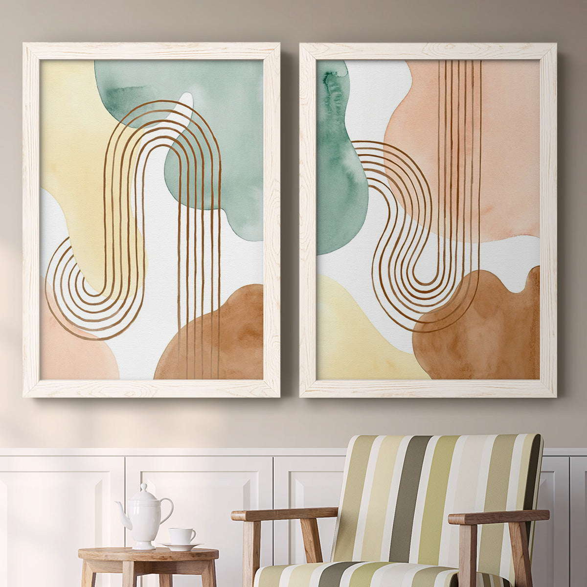 Set of two white barnwood framed canvas prints depicting two folk-inspired botanical patterns featuring repeating indigo floral and leaf motifs above a sideboard in a cozy sitting room.