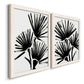 Angled view of a set of two white barnwood framed canvas prints featuring two bold monochrome botanical prints featuring black fan-shaped botanical forms.