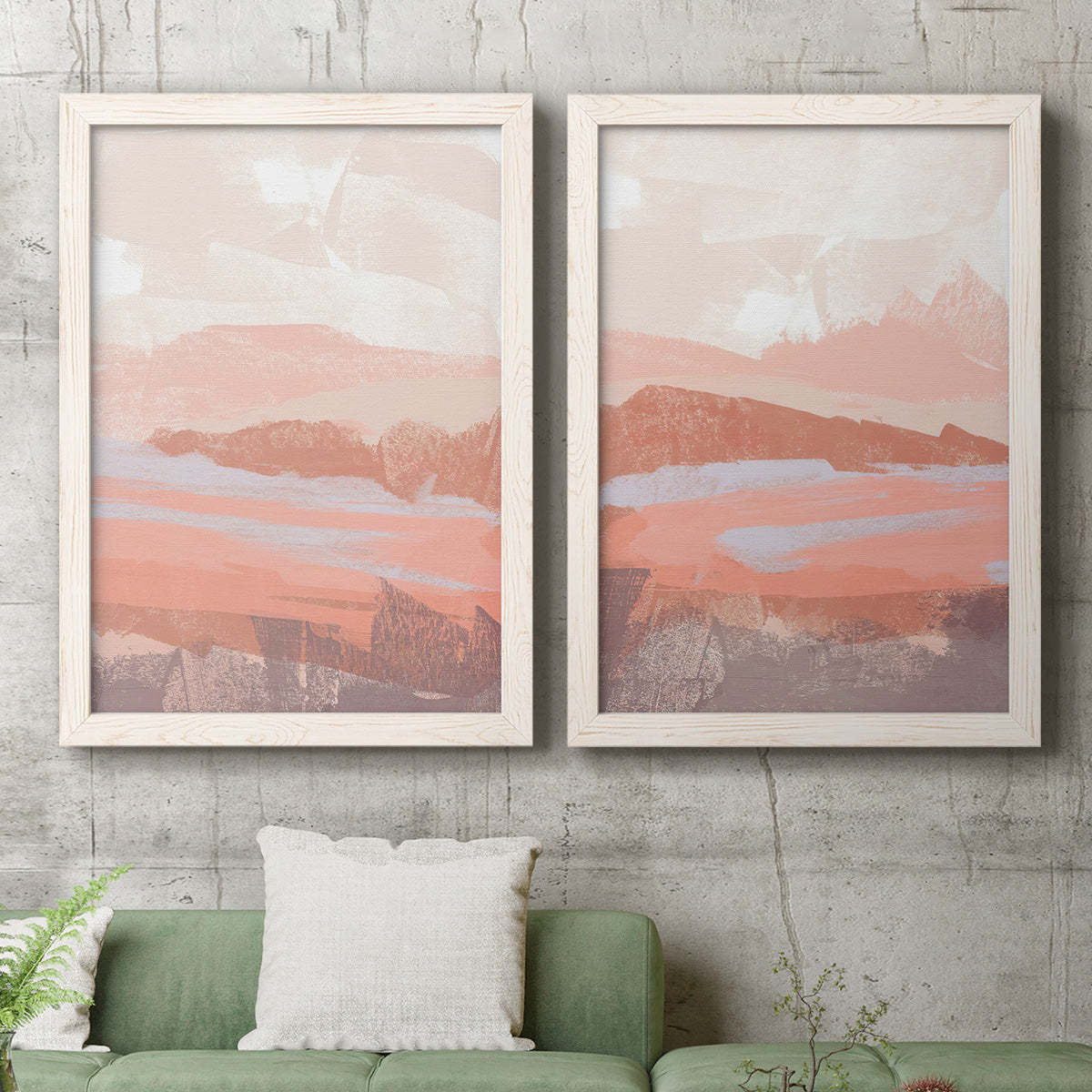 Set of two white barnwood framed canvas prints depicting a coordinated art pair of layered blush terracotta and blue desert horizons rendered as modern abstract landscapes above a sofa in a modern living room.