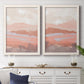 Set of two white barnwood framed canvas prints depicting a coordinated art pair of layered blush terracotta and blue desert horizons rendered as modern abstract landscapes above a dining room sideboard.