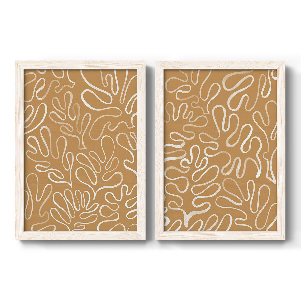 Set of two white barnwood framed canvas prints featuring two graphic botanical pattern abstracts featuring continuous white organic lines over solid ochre and blush fields.
