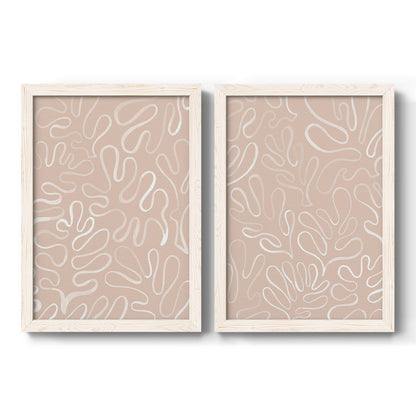 Set of two white barnwood framed canvas prints featuring two graphic botanical pattern abstracts featuring continuous white organic lines over solid ochre and blush fields.
