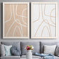 Set of two white barnwood framed canvas prints depicting paired minimalist line abstracts with warm beige grounds, white contour paths, and quiet negative space above a sofa in a contemporary living room.