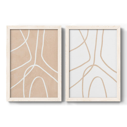 Set of two white barnwood framed canvas prints featuring two minimalist line abstracts featuring single continuous tan lines forming oversized organic curves.