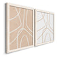 Angled view of a set of two white barnwood framed canvas prints featuring two minimalist line abstracts featuring single continuous tan lines forming oversized organic curves.