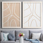 Set of two white barnwood framed canvas prints depicting paired minimalist line abstracts with warm beige grounds, white contour paths, and quiet negative space above a sofa in a contemporary living room.