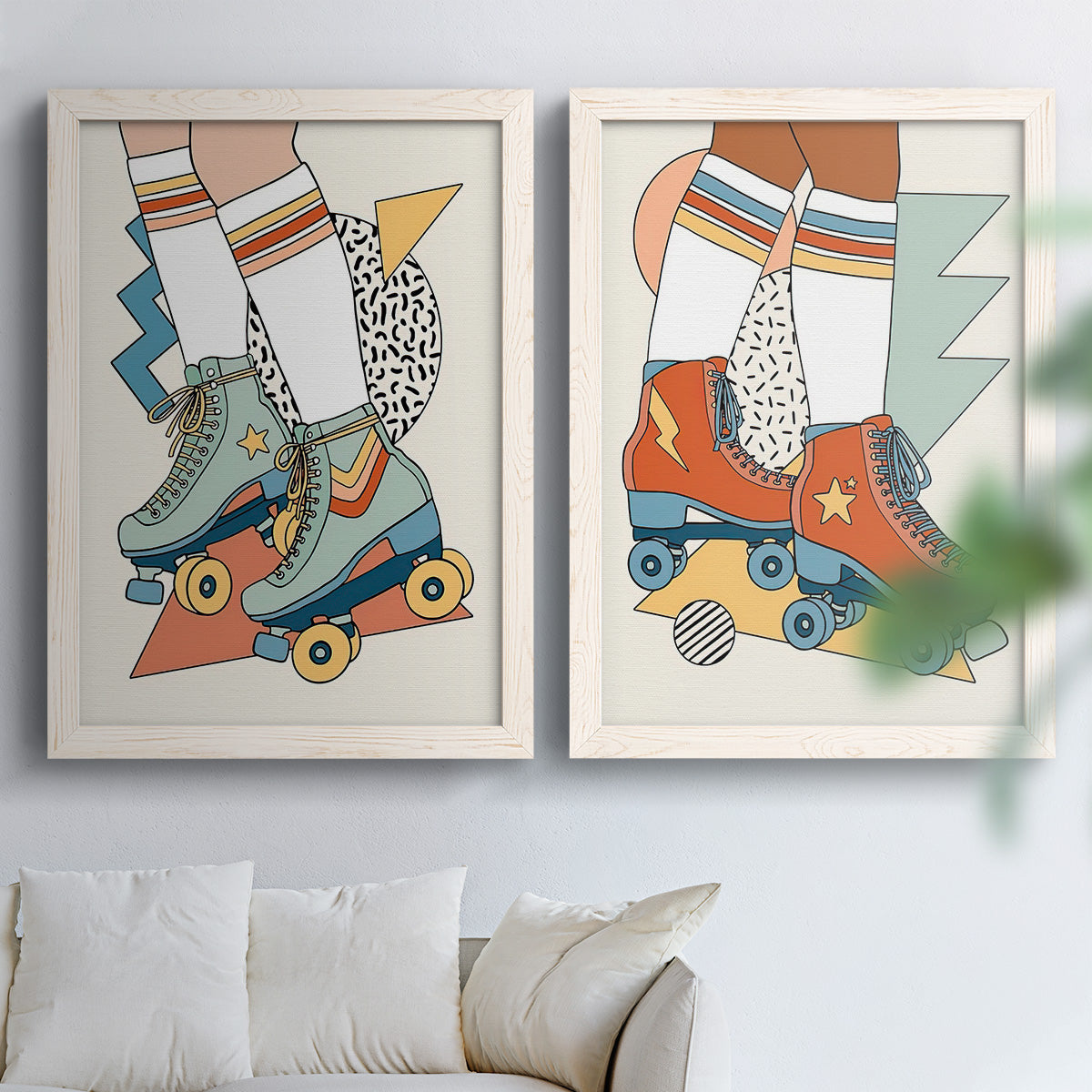 Set of two white barnwood framed canvas prints depicting orange teal and blue skates, star details, and graphic geometric accents arranged across two complementary compositions above a sofa in a bright living space.
