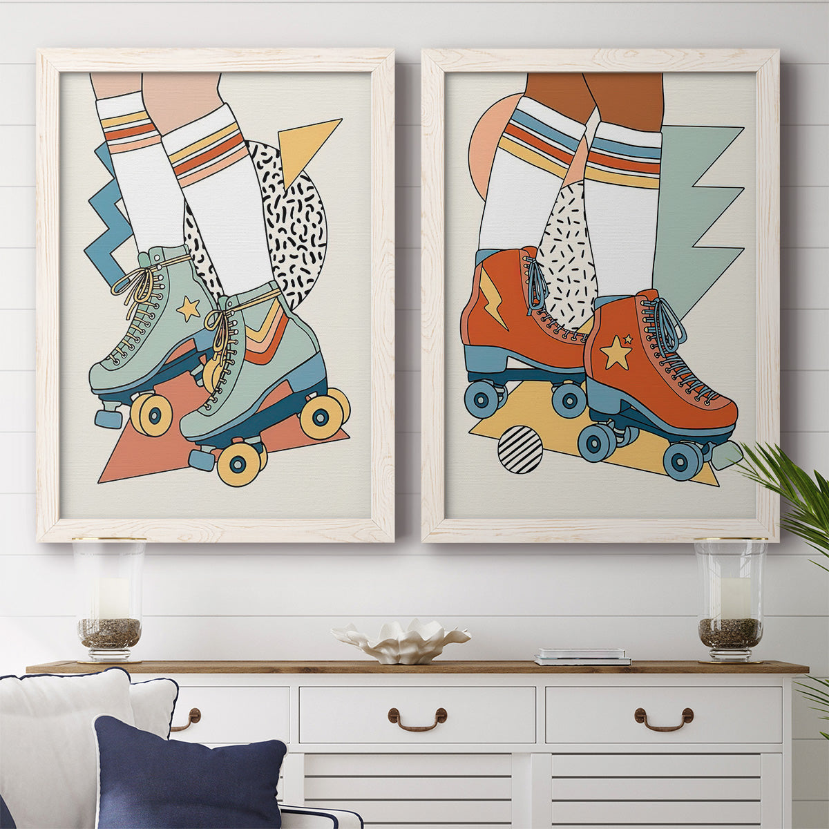 Set of two white barnwood framed canvas prints depicting a coordinated art pair of colorful retro roller skates and patterned socks rendered as playful fashion illustrations above a dining room sideboard.