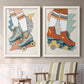 Set of two white barnwood framed canvas prints depicting two playful fashion illustrations featuring colorful retro roller skates and patterned socks above a sideboard in a cozy sitting room.