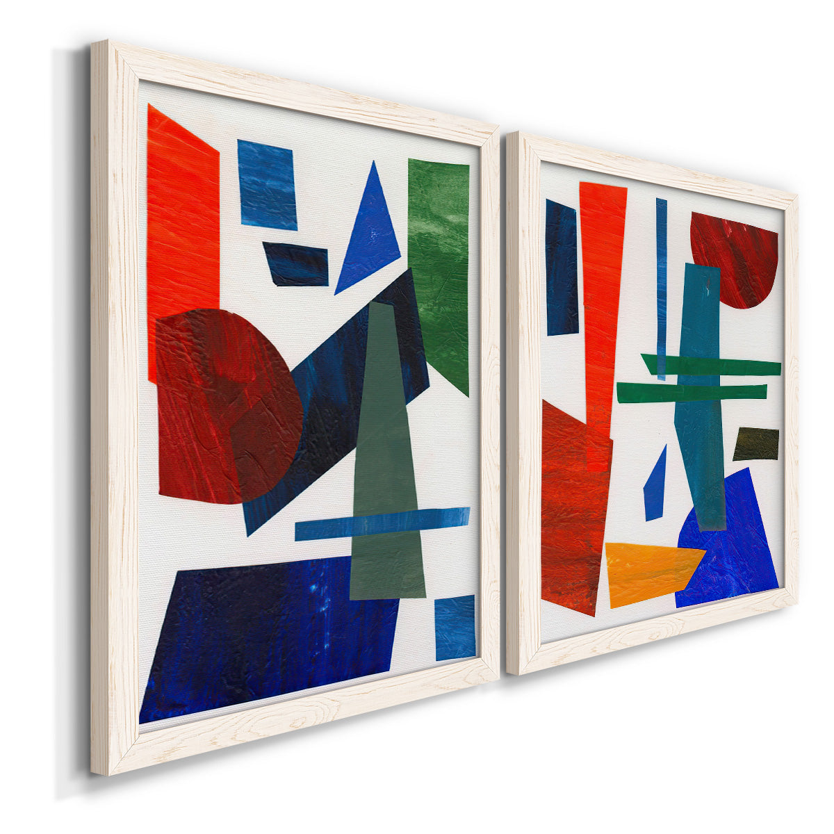 Angled view of a set of two white barnwood framed canvas prints featuring two mid-century graphic abstracts featuring bold red blue green yellow and black geometric forms.