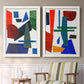 Set of two white barnwood framed canvas prints depicting two mid-century graphic abstracts featuring bold red blue green yellow and black geometric forms above a sideboard in a cozy sitting room.