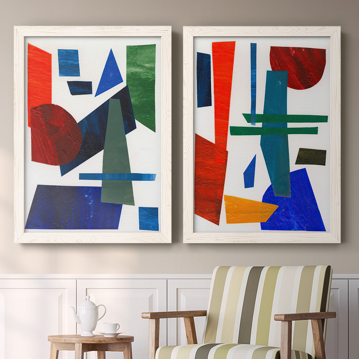 Set of two white barnwood framed canvas prints depicting two mid-century graphic abstracts featuring bold red blue green yellow and black geometric forms above a sideboard in a cozy sitting room.
