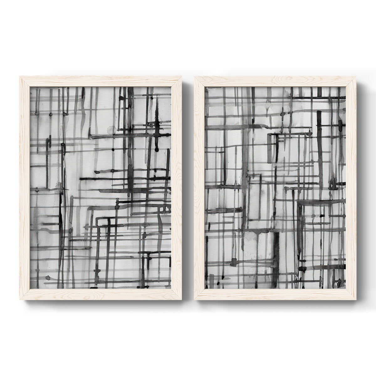 Set of two white barnwood framed canvas prints featuring two monochrome geometric abstracts featuring layered black linear grids.