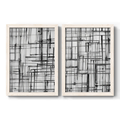 Set of two white barnwood framed canvas prints featuring two monochrome geometric abstracts featuring layered black linear grids.