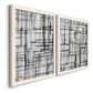 Angled view of a set of two white barnwood framed canvas prints featuring two monochrome geometric abstracts featuring layered black linear grids.