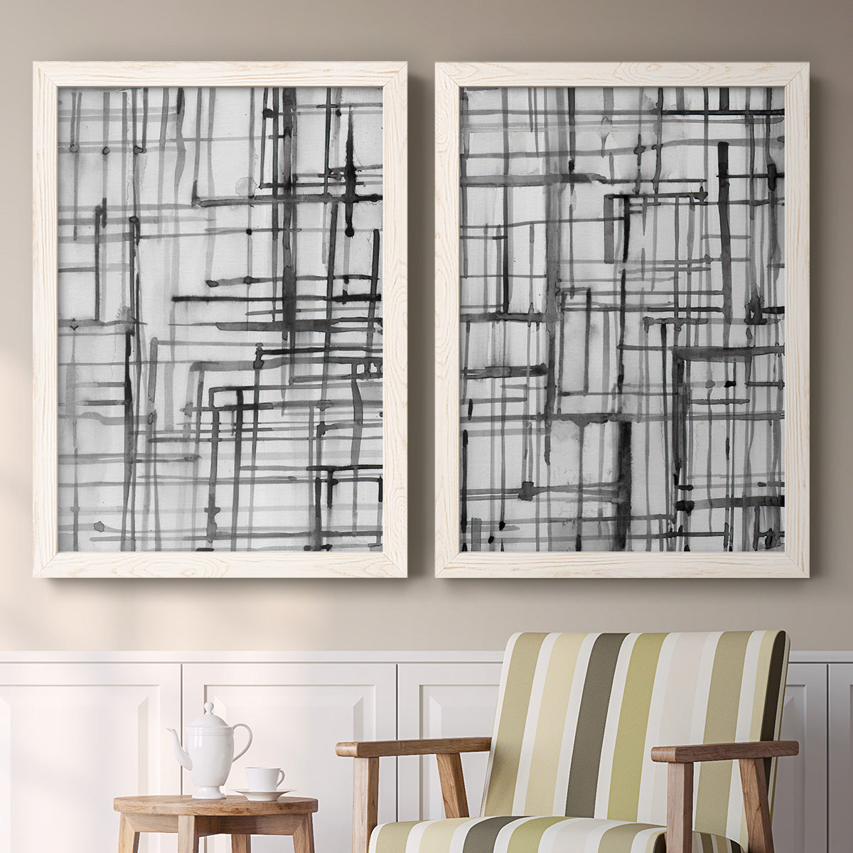 Set of two white barnwood framed canvas prints depicting two monochrome geometric abstracts featuring layered black linear grids above a sideboard in a cozy sitting room.