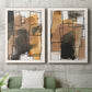 Set of two white barnwood framed canvas prints depicting a coordinated art pair of earthy watercolor blocks crossed by black contour lines rendered as retro geometric abstracts above a sofa in a modern living room.